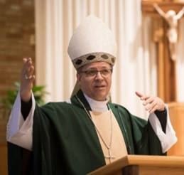 Bishop Rojas preaching in green vestments and a mitre